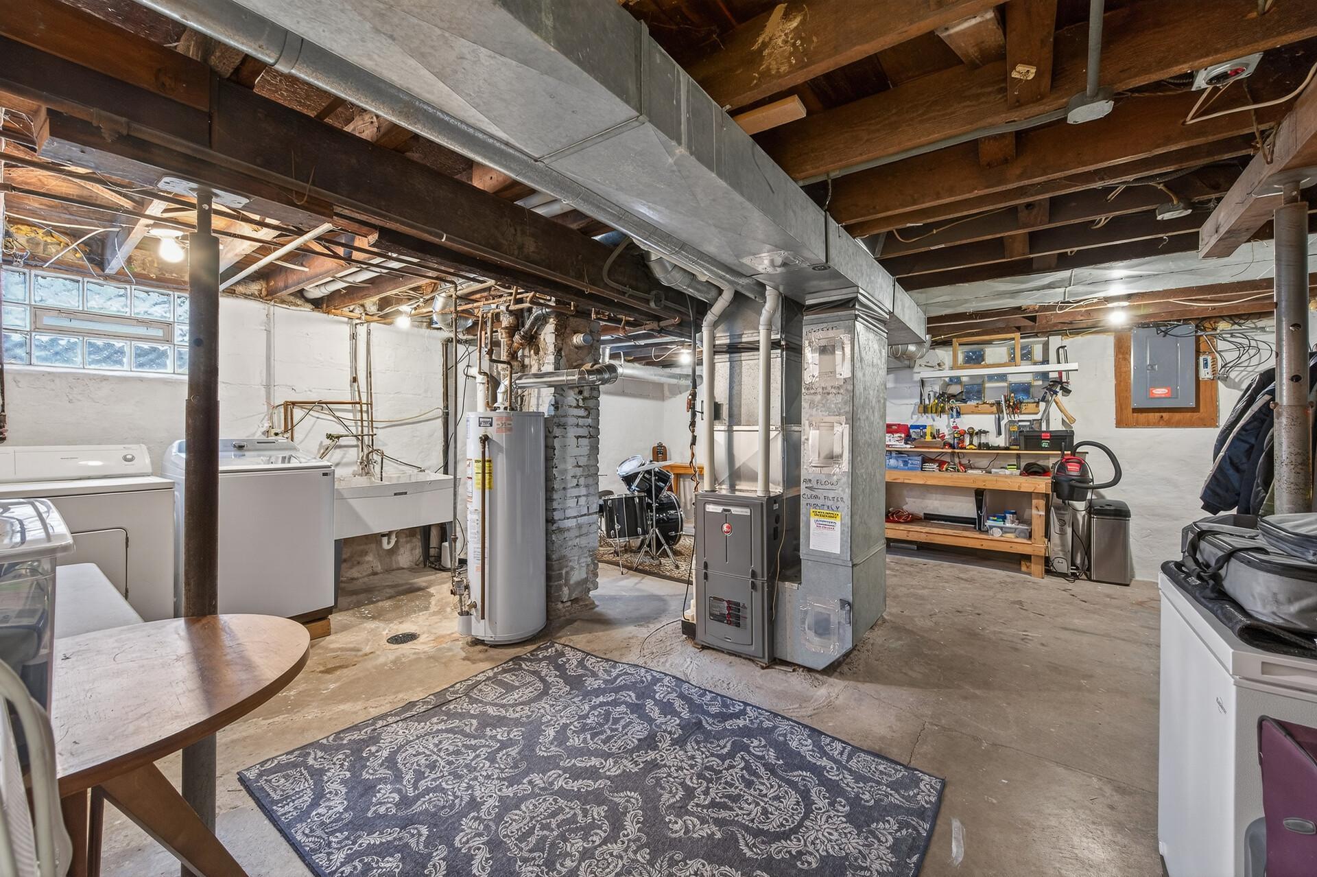 Full basement with high ceilings, newer boiler, and electrical panel.