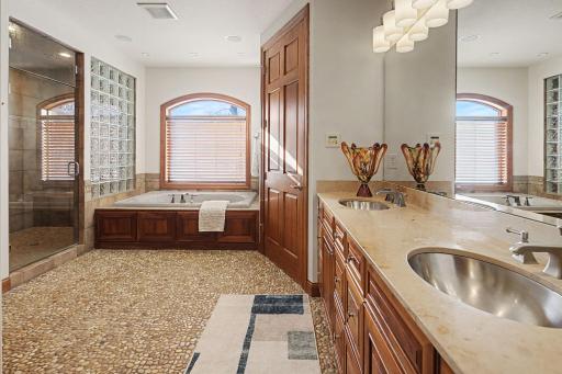 Primary Suite Bath with double sink vanity, private water closet, jetted bathtub, walk in steam shower