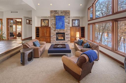 Great Room with Fireplace-Built-ins-Vaulted Ceiling-Expansive windows to woods and pond