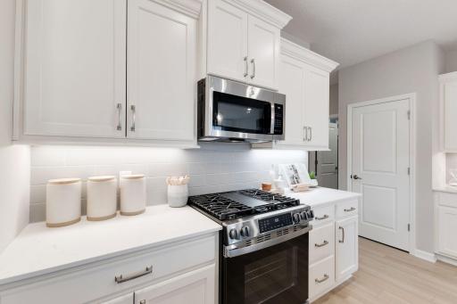 GE stainless appliances including a gas range, microwave, dishwasher, and refrigerator are all included! Photo of model home, colors and finishes may vary.