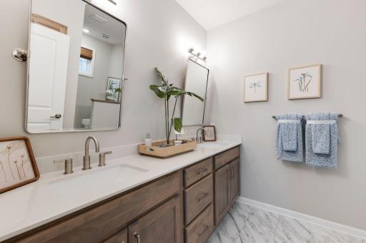 The primary bath is generously sized with dual sinks and tons of cabinet space!