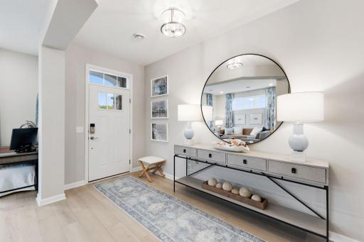 Spacious front entry that opens to your den/office space! Photo of model home, colors and finishes may vary.