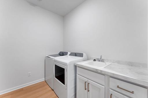 GE washer & dryer, included with the home, along with a laundry sink with cabinet and countertop space!