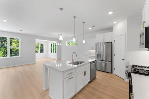 Open concept kitchen, dining, and family room give the home a light and airy feeling.