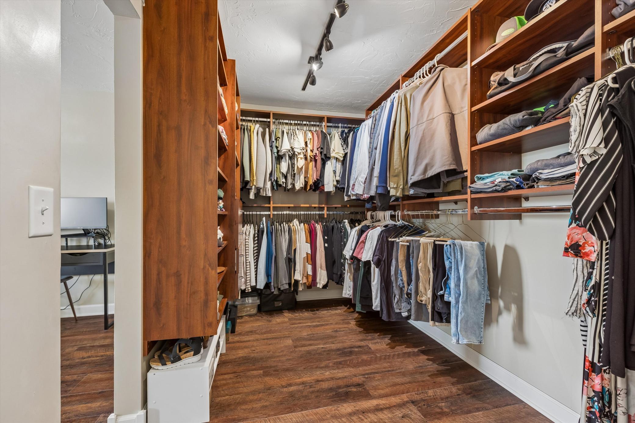 Expansive walk-in closet thoughtfully designed with ample storage and a refined, boutique-inspired atmosphere