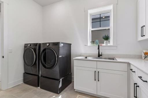 The well-appointed laundry room offers extra storage too.