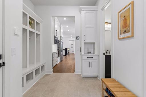Ideal entry from the garage combines mudroom and a huge closet for gear storage.