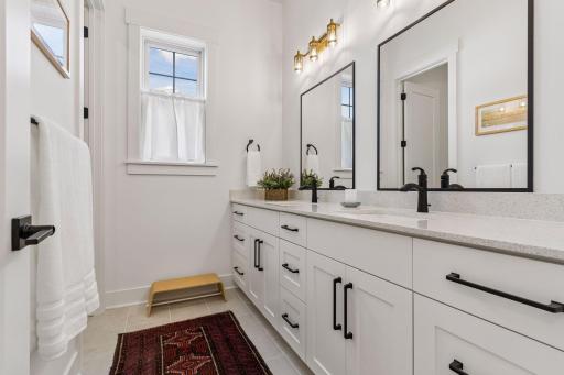 Abundant creature comforts with double sinks in the guest bathroom.