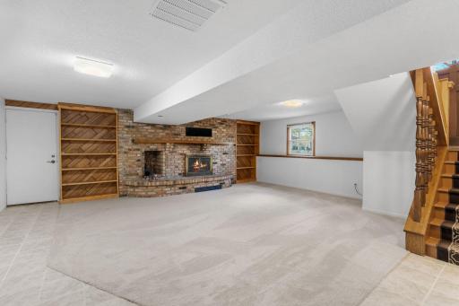 Lower level family room with timeless built-ins and entry to garage