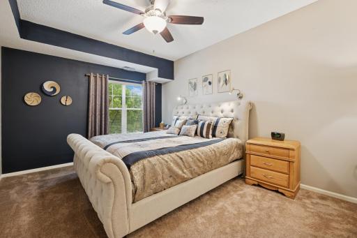 Primary with a ceiling fan, walk-in closet and private bath