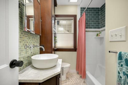 The bathroom has been thoughtfully remodeled (previous owners) with custom cabinetry.