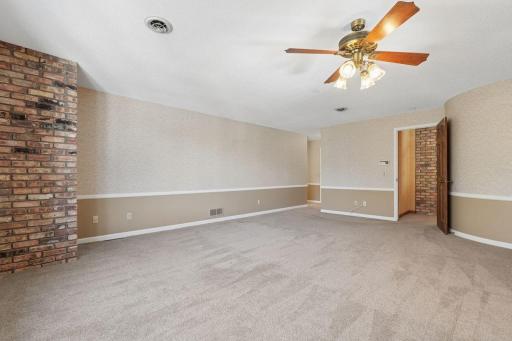 âLarge primary bedroom with neutral finishes."