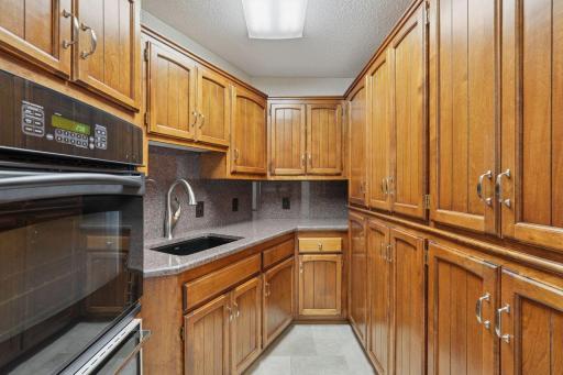 âWell-appointed butlerâs pantry with extensive cabinetry, granite counters, prep sink, and built-in oven with warming drawerâperfect for staging meals and adding extra storage and workspace.â
