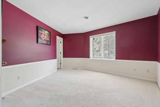 âLarge bedroom with bright natural light, featuring crisp two-tone walls, neutral carpet, and a spacious layout with a wide picture windowâan ideal upper-level retreat with ensuite access.â