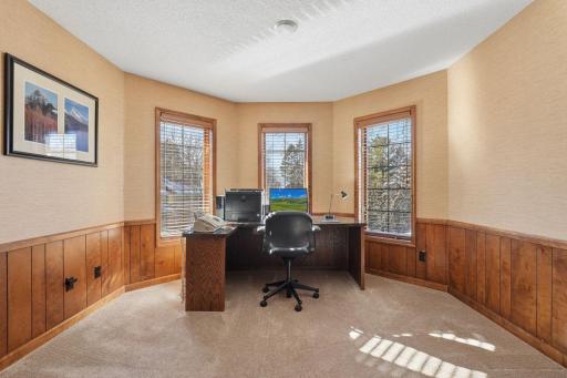 âTurret-style office just off the hallway, featuring wrap-around windows and warm wood wainscotingâan ideal private workspace.â