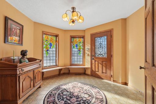 Front entry graced with beautiful stained glass and leaded front door encompassing the turret.