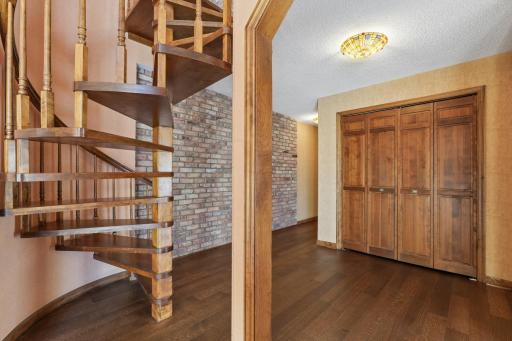 Beautifully crafted circular stairway off entry.