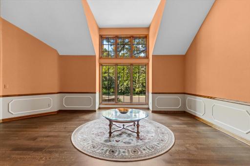 Living room with waults and boxed out windows brings the nature inside.