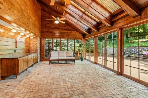 Chicago brick floors, built in hutch, skylights and soaring vaults walks out to deck with floor to ceiling windows! This room is a show stopper!