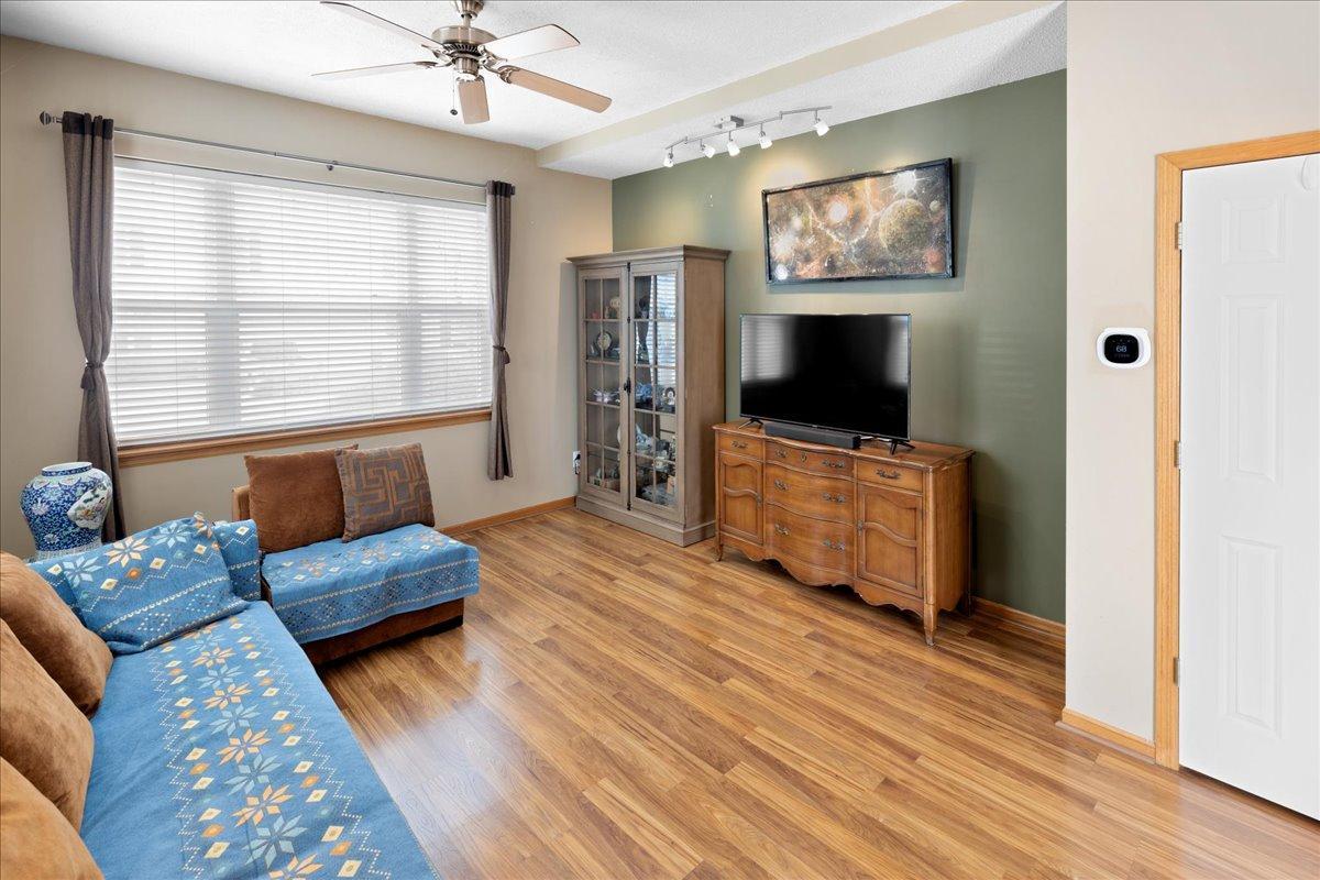 Bright living room with large windows facing south and west, updated flooring, and modern accent wall.
