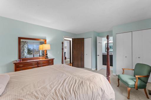 Primary bedroom with view to pass through bath and his and hers closets