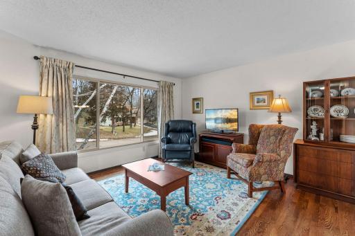 Family room with large windows providing natural light. Family room with hardwood floors!