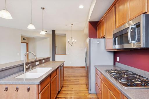 Convenient center island with double sink and dishwasher, providing additional prep space and casual seating.