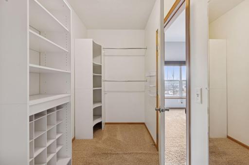 The Primary bedroom boasts a large walk-in closet with custom shelving and built-in organization for optimal storage.