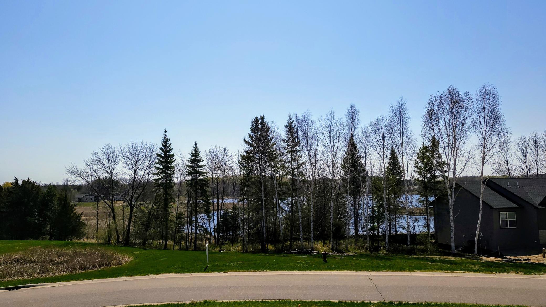 The home will be located beyond the tree line with the front approximately at/on the tree line between the pond and fire hydrant.