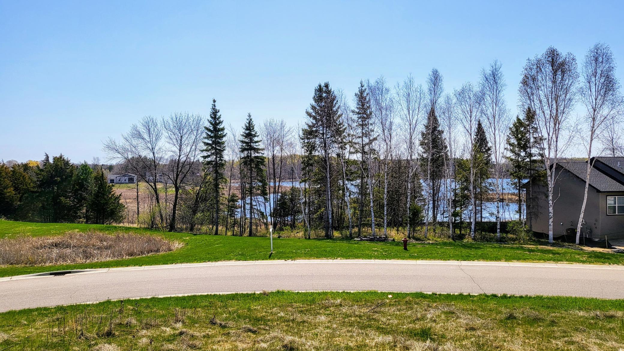 Home likely to be located to the right of the front yard pond and the front door would be at the tree line. East view from across Orchard Ct