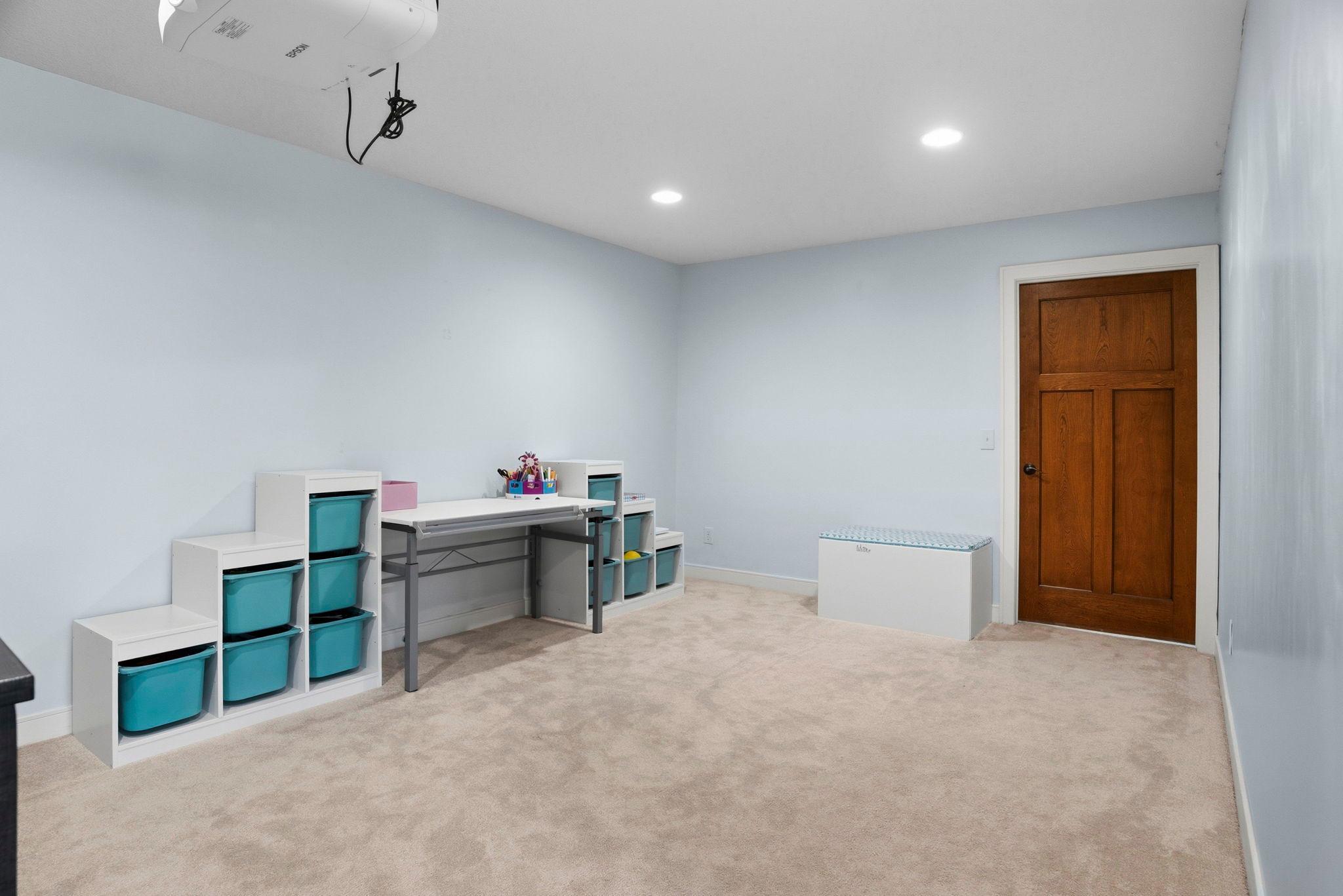 Play zone in lower level with fresh carpet.