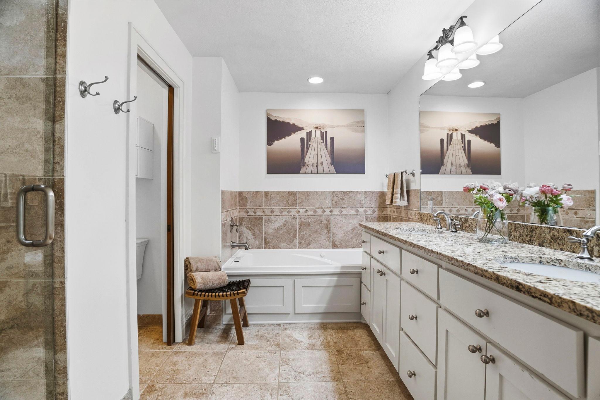 Dreamy primary bath with large showing and huge jetted tub.