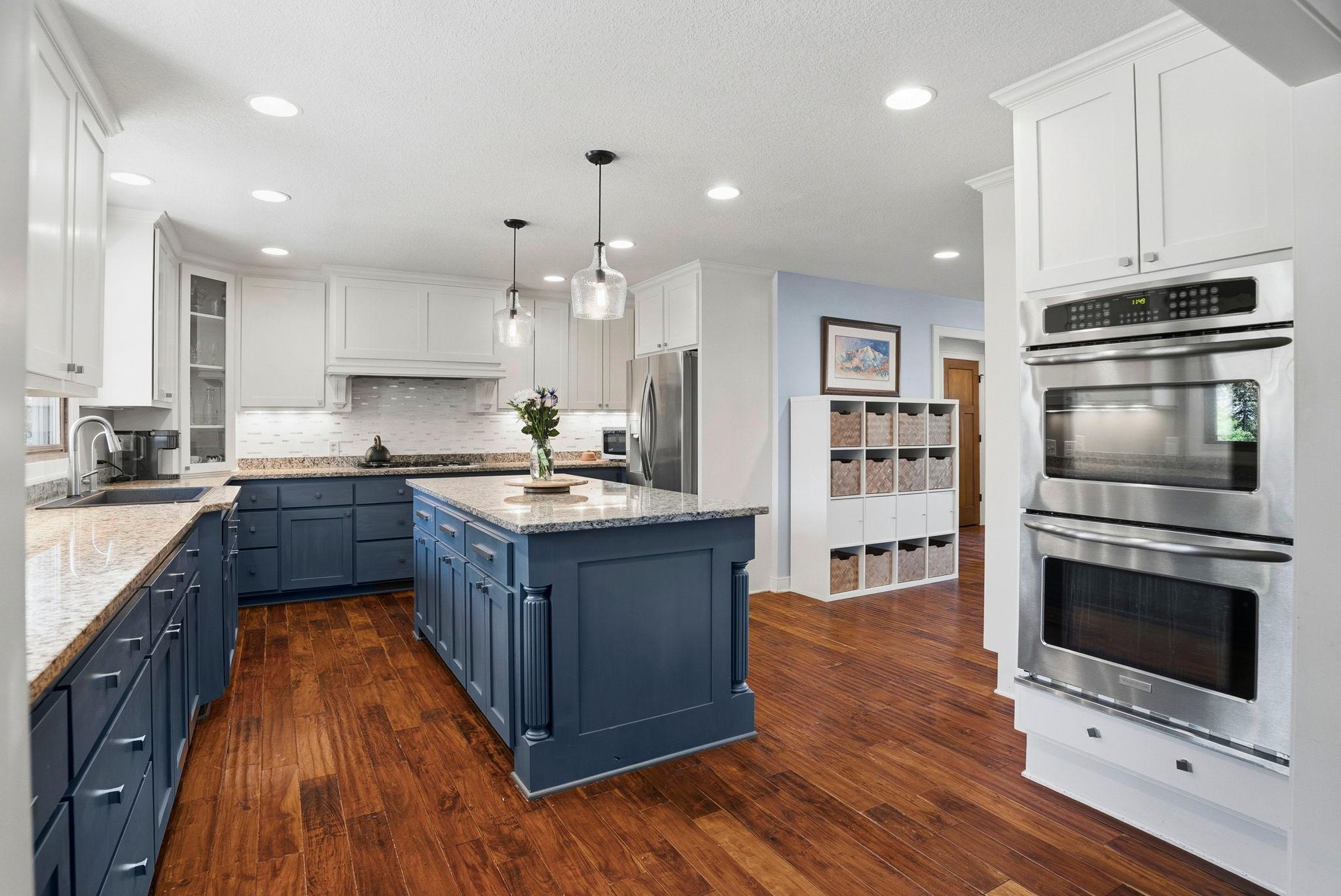 Spacious kitchen with breakfast bar and ample lighting.
