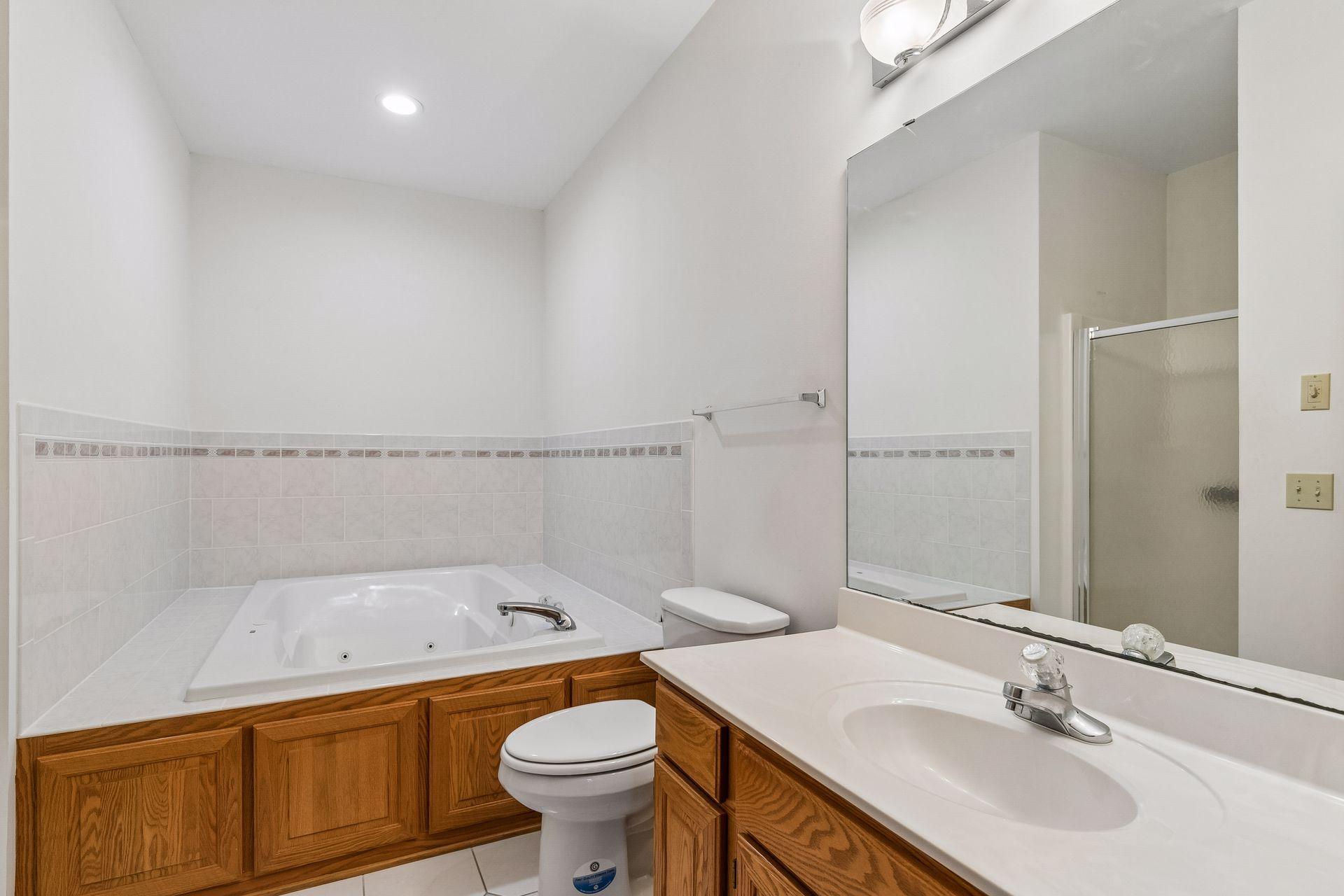 Ready to relax in the jetted tub? I see candles and relaxing music in this space