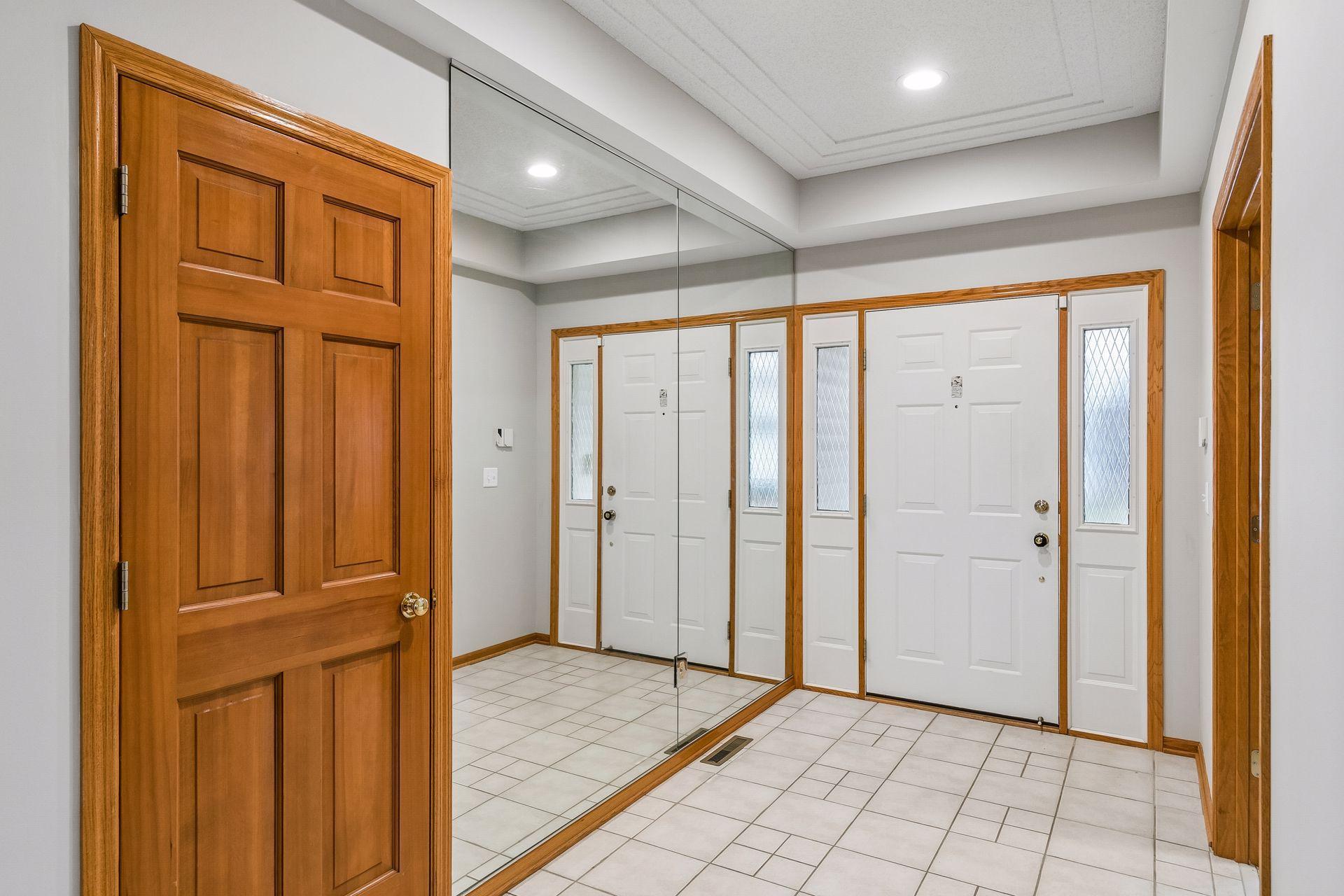 Front foyer with tile floors, double sidelights at the door and large full mirrors so you know that you look good when you are leaving.
