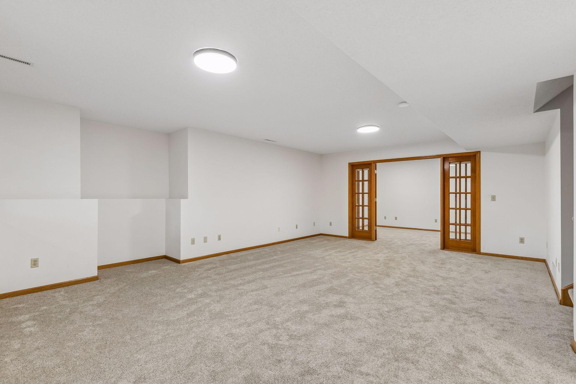 Large Basement family room space with potential for a second fireplace as it is already roughed in and easy to add one here on the left. Or you can use that space for a built in set of cabinets.