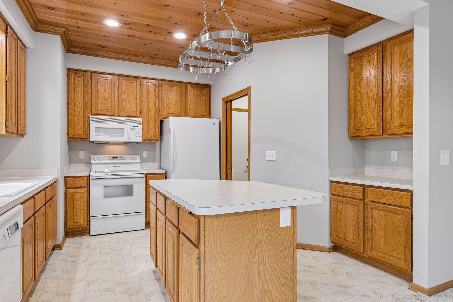 Notice the beautiful wood ceiling with crown molding in the kitchen area