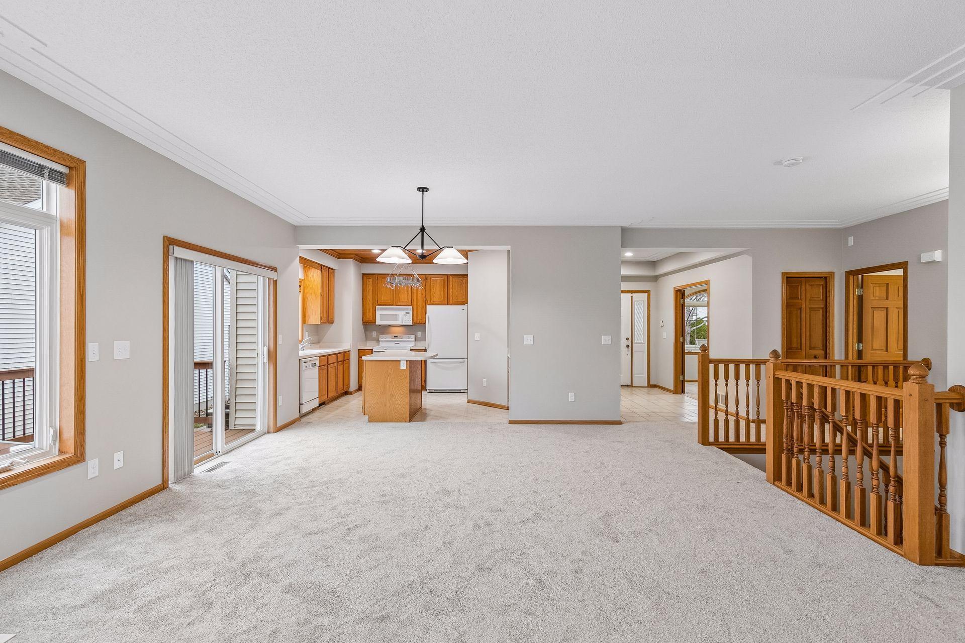 Living room and Dining with 9' ceilings. Also, notice the large switchback staircase going down...nice to have a landing on the stairs halfway down.