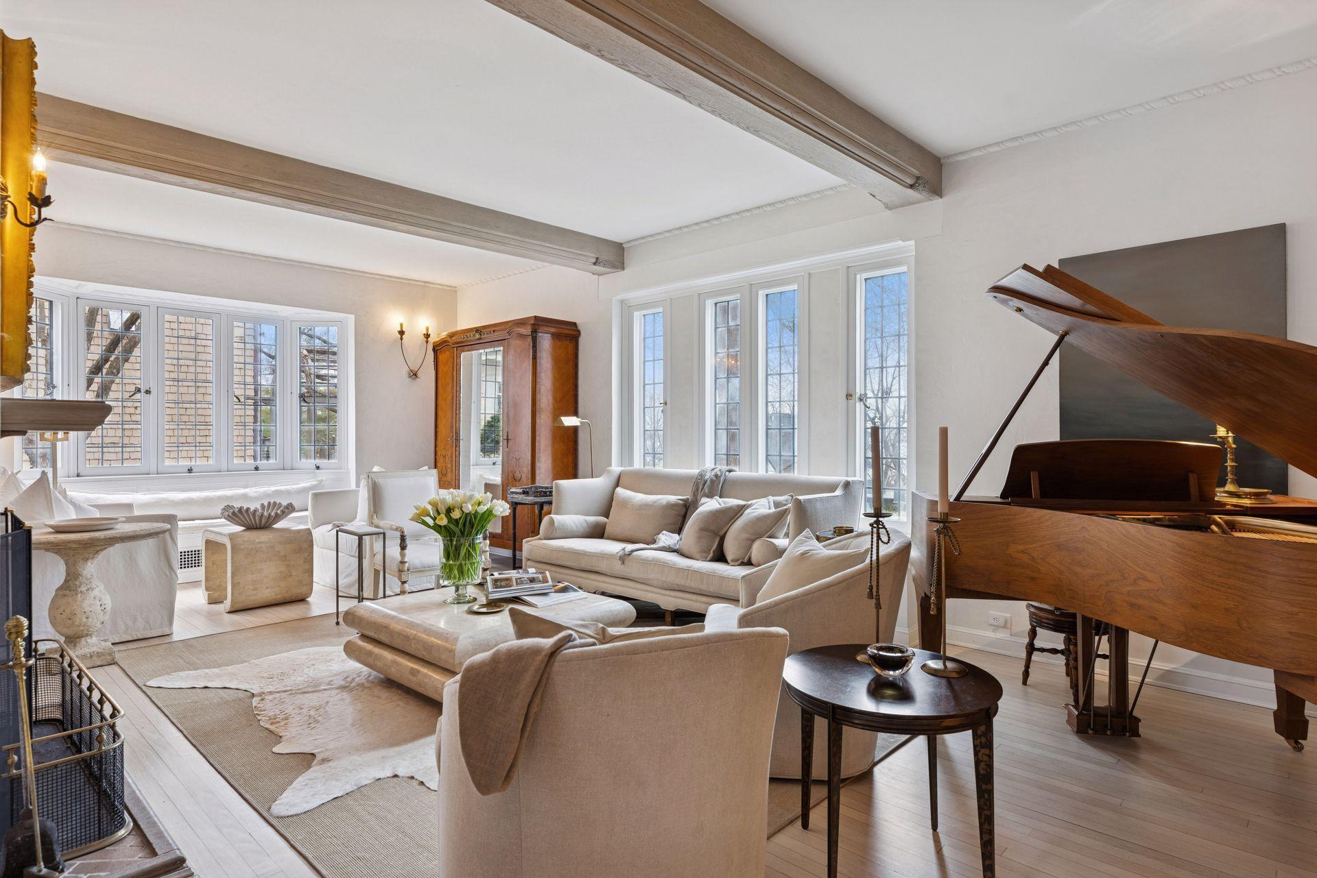 The inviting formal living room is spacious with room for two seating areas and a piano. Gorgeous windows facing south and west provide abundant natural light and stunning sunset views.