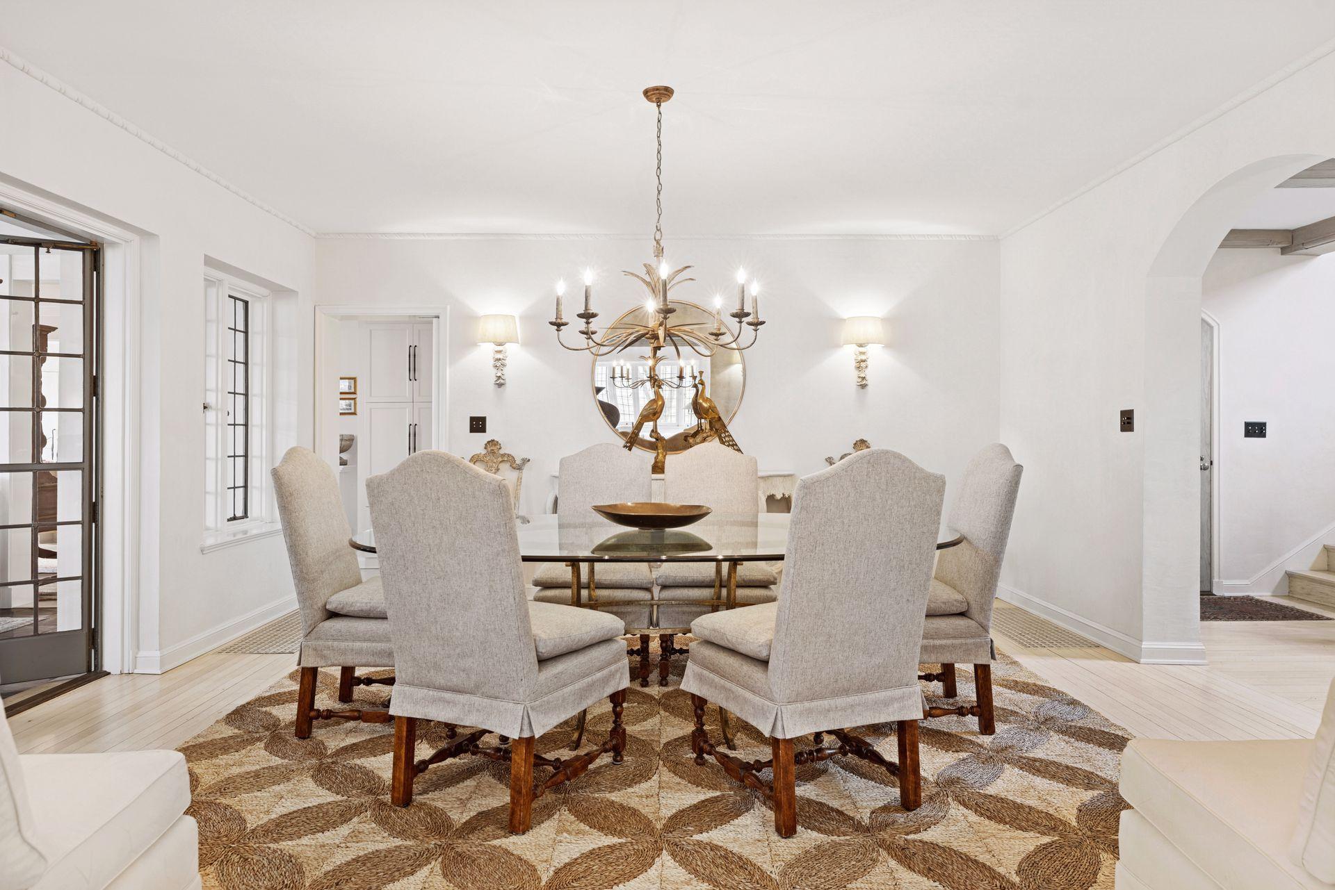 Spacious formal dining room with two wide arched doorways, kitchen access, and divided light French doors leading to the family room.