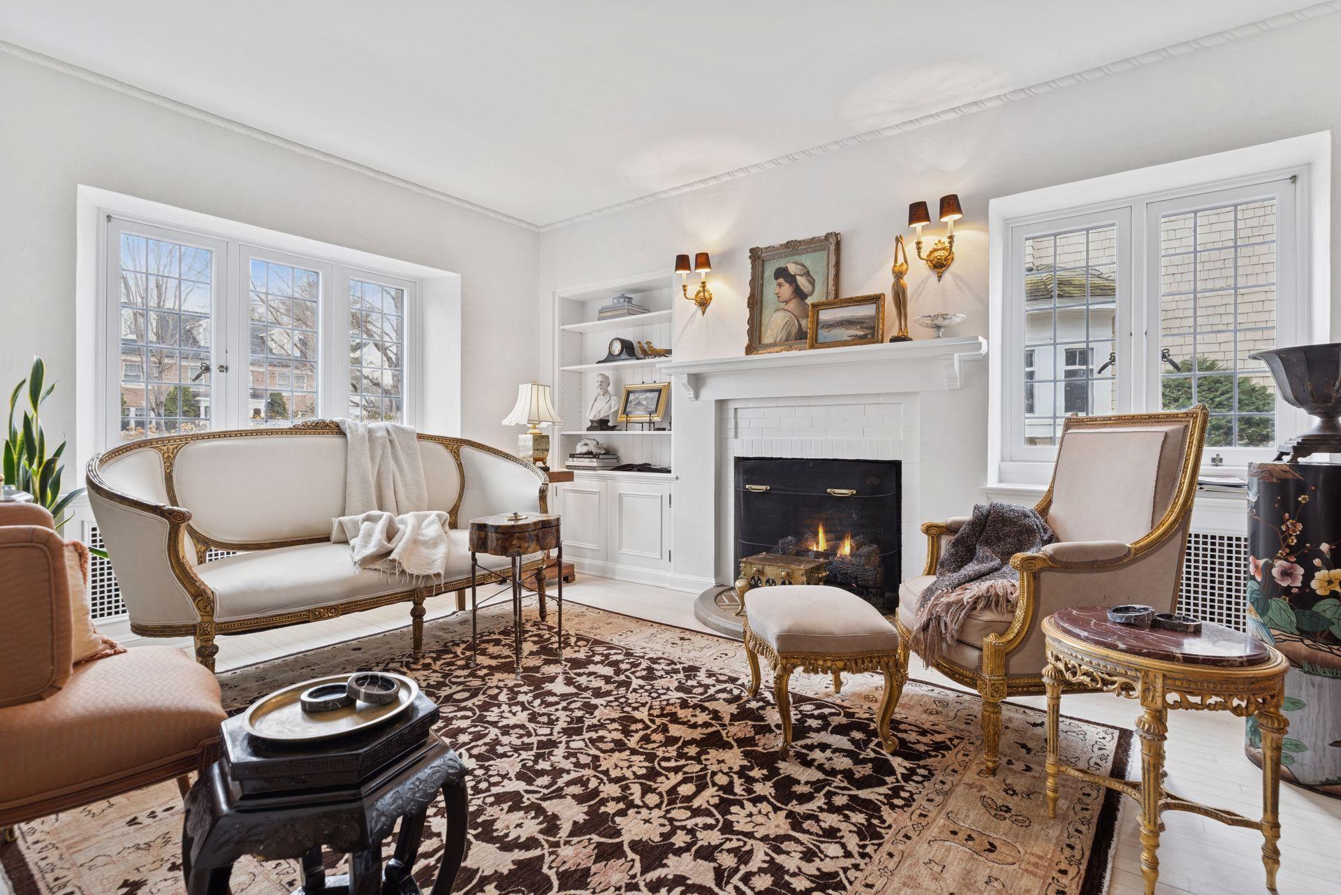 Cozy main level den/office with east and south facing windows along with a gas log set fireplace and built-in library shelving with lower cabinets.