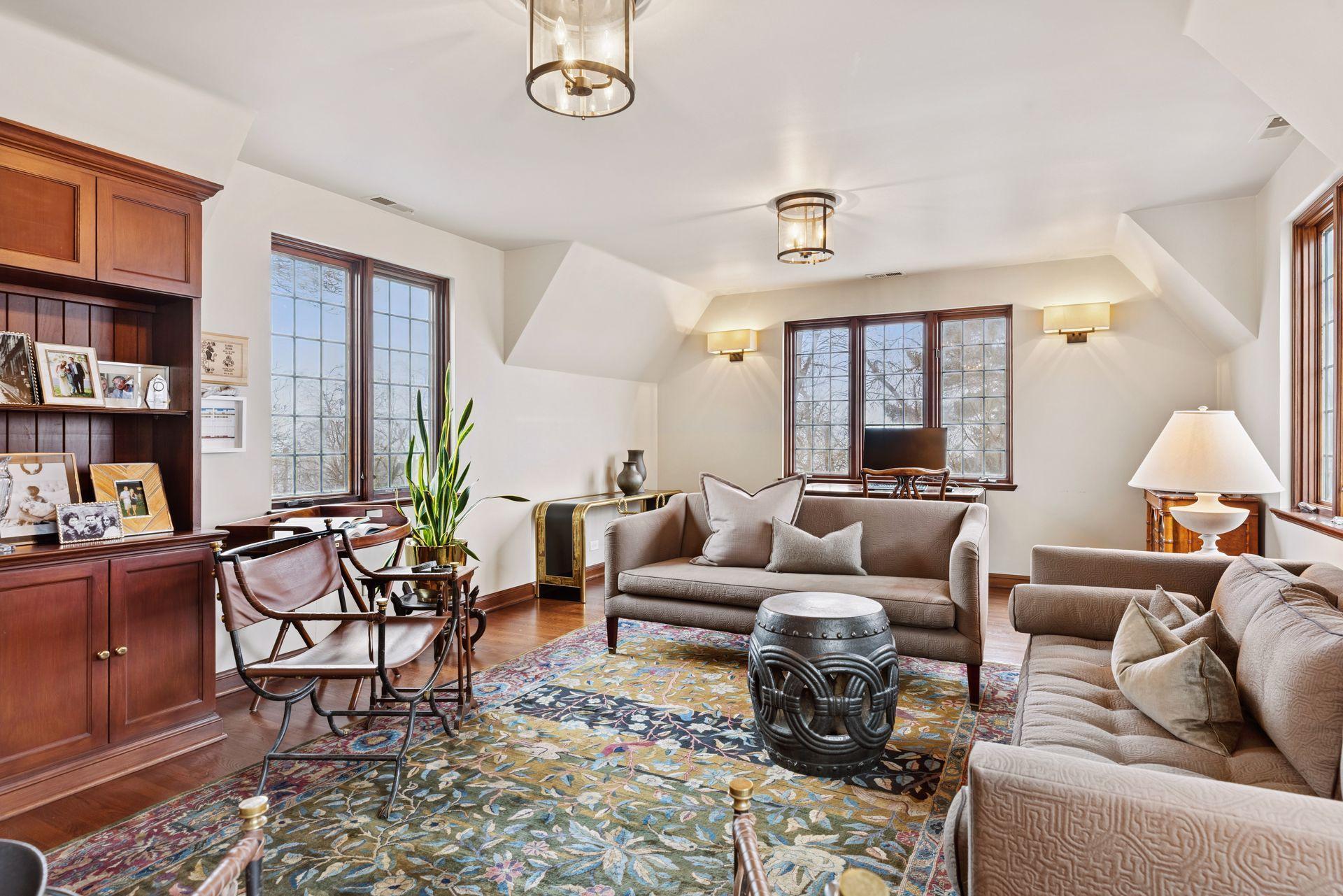 The 5th bedroom includes a walk-in closet, built-in drawers and cabinetry, and a built-in library shelf and media cabinet. A secondary staircase from this bedroom wing leads directly to the kitchen.
