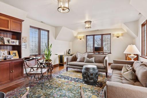 The 5th bedroom includes a walk-in closet, built-in drawers and cabinetry, and a built-in library shelf and media cabinet. A secondary staircase from this bedroom wing leads directly to the kitchen.