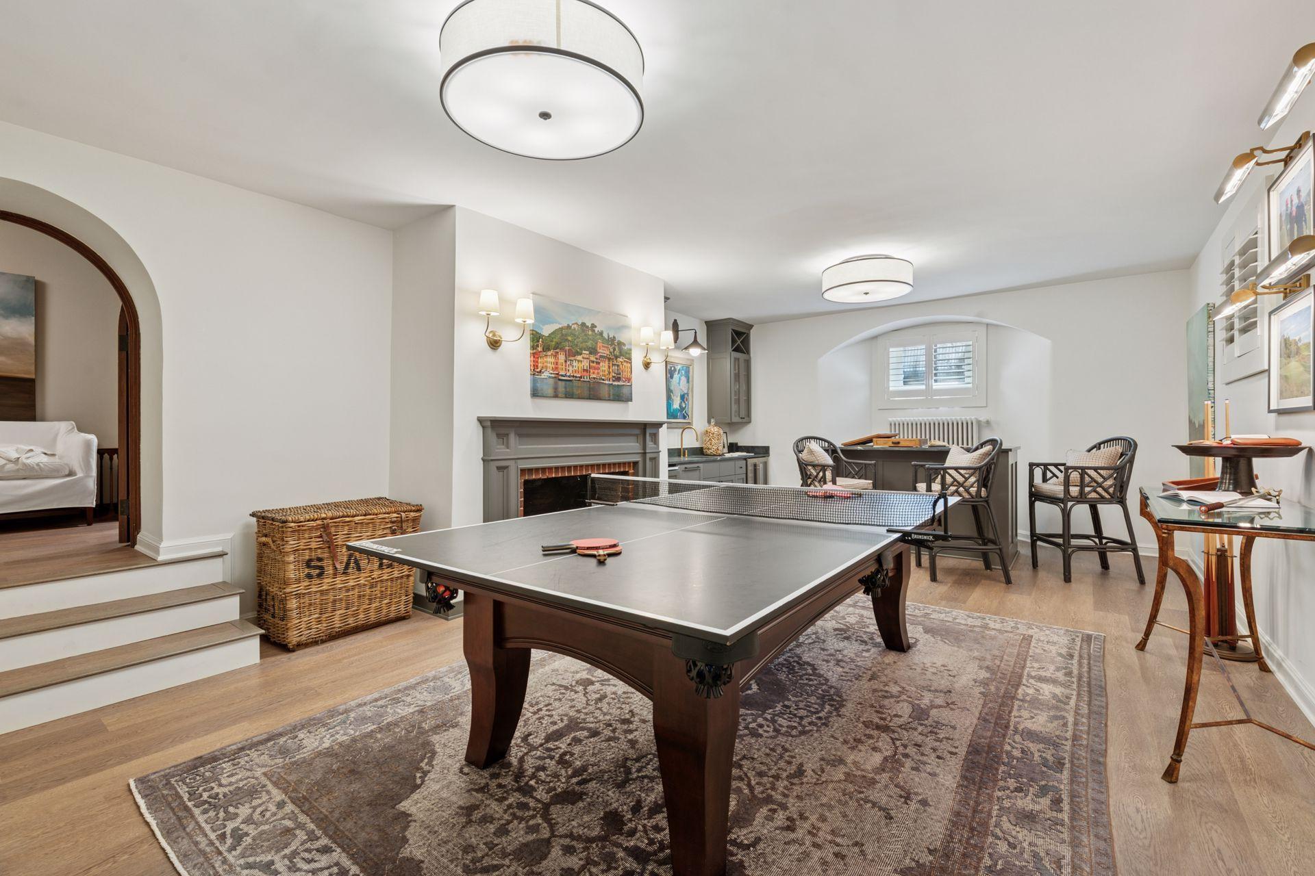 Lower level recreation room. The fireplace is currently decorative only with an existing gas line for a future insert, if desired.