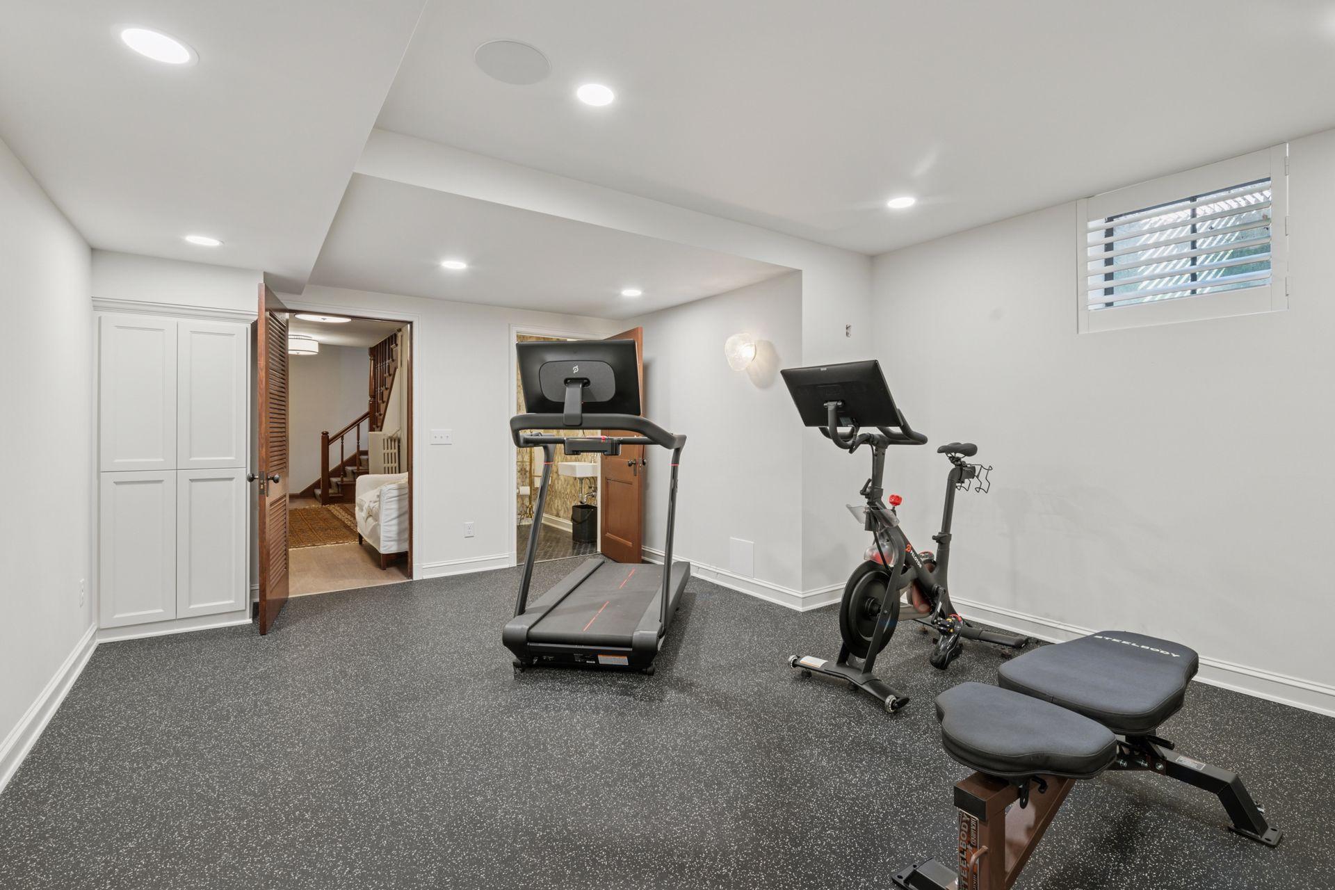 Lower level fitness room with a new half bath.