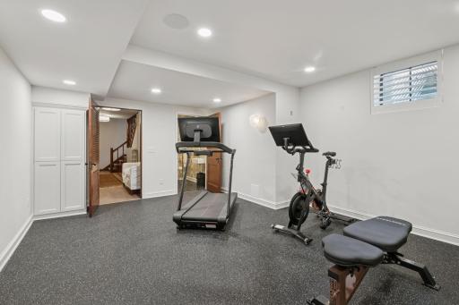 Lower level fitness room with a new half bath.