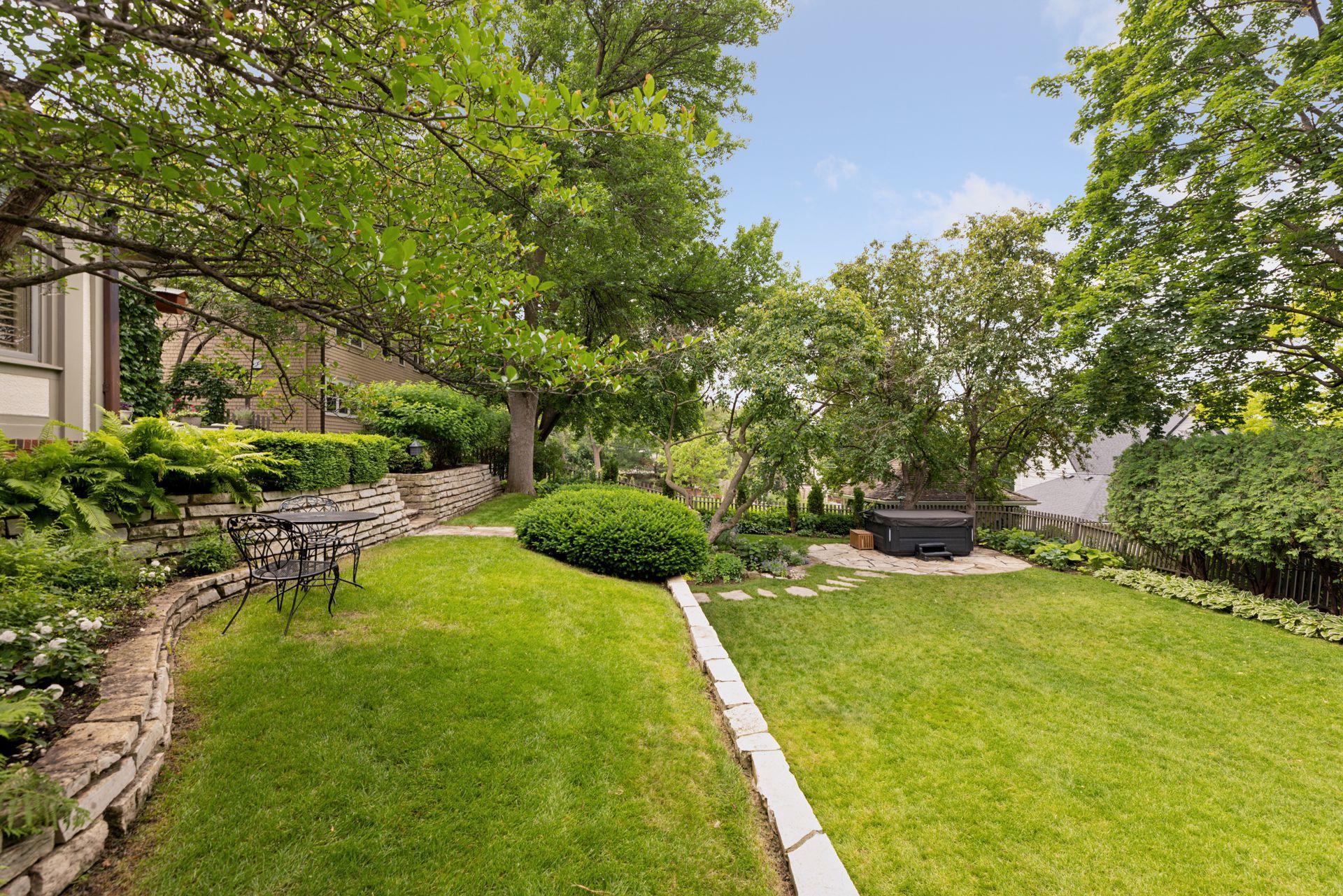 An upper level lawn overlooks that wide flat yard.