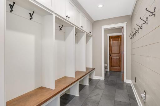 Just off the insulated and beautifully finished garage and side entry door is the mudroom, 1/2 bathroom, and walk-in pantry closet providing plenty of space for the big Costco hauls.