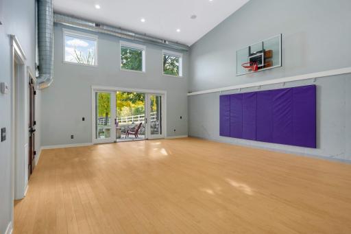 On the opposite end of the lower level is the awesome sport court that's wired up for a projector and has changeable LED lighting - this is so much more than a gym - think community yoga events, hosting parties, sleepovers, and more.