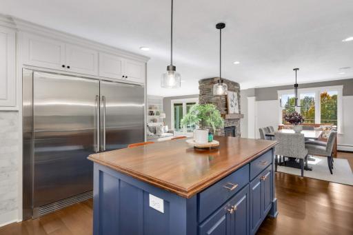 The custom cabinetry was so thoughtfully designed and you'll love the designer hardware and lighting. The cupboard next to the refrigerator houses a planner calendar to keep busy schedules on track.